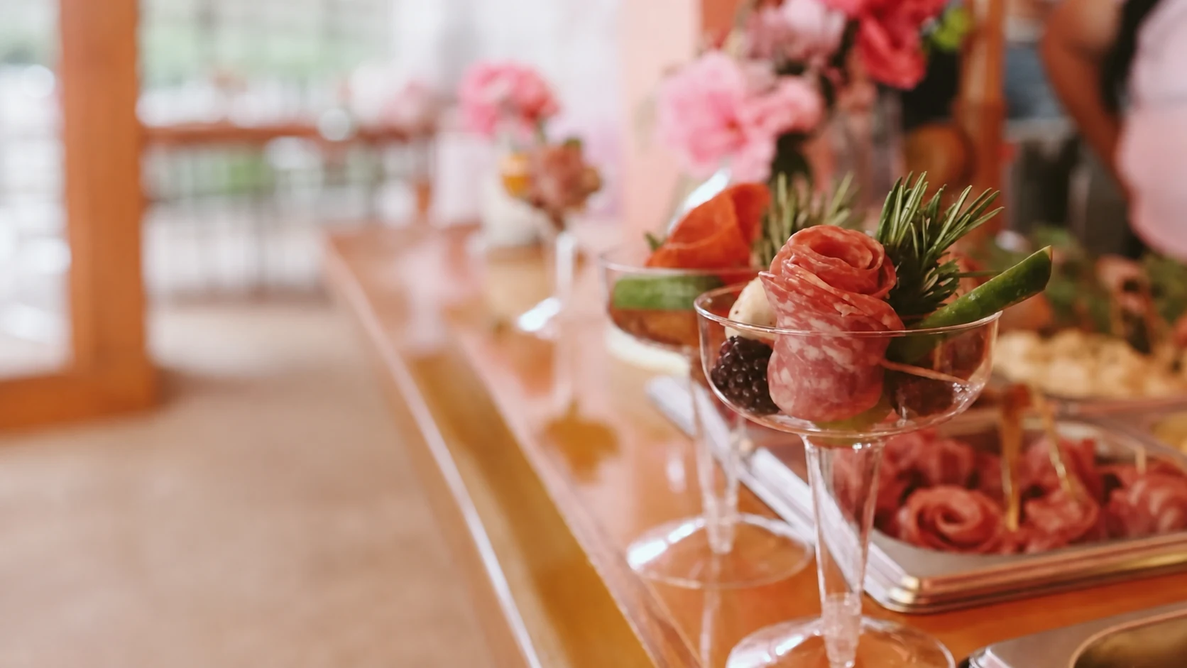 Individual charcuterie cups with salami roses and berries at a San Diego gathering